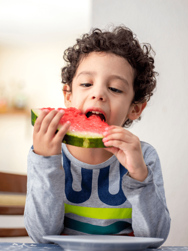 Young beautiful woman eating fresh watermelon stock photo